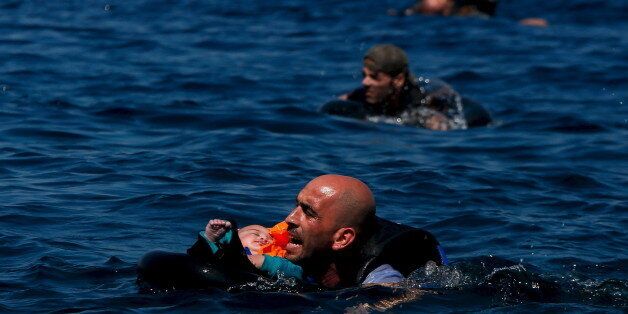 A Syrian refugee holding a baby swims towards the Greek island of Lesbos, September 12, 2015.  Alkis Konstantinidis: Another inflatable boat packed with dozens of migrants and refugees heading towards the shore. Thatâs what I noticed in the distance. The sea was calm and they were cheering on the dinghy. Suddenly, some 200 metres away, the rear of the boat deflated for no obvious reason, and people started falling into the sea. Screams replaced cheers as they frantically tried to stay afloa