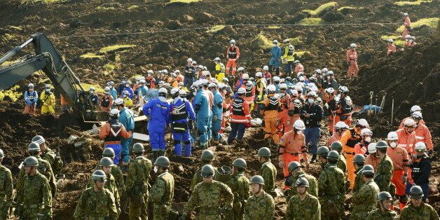 Rescue workers and Japan Ground Self-Defense Force soldiers conduct search and rescue operations at site where collapsed houses by a landslide caused by an earthquake in Minamiaso town, Kumamoto prefecture, Japan, in this photo taken by Kyodo April 20, 2016. Mandatory credit Kyodo/via REUTERS   ATTENTION EDITORS - THIS IMAGE WAS PROVIDED BY A THIRD PARTY. EDITORIAL USE ONLY. MANDATORY CREDIT. JAPAN OUT. NO COMMERCIAL OR EDITORIAL SALES IN JAPAN.