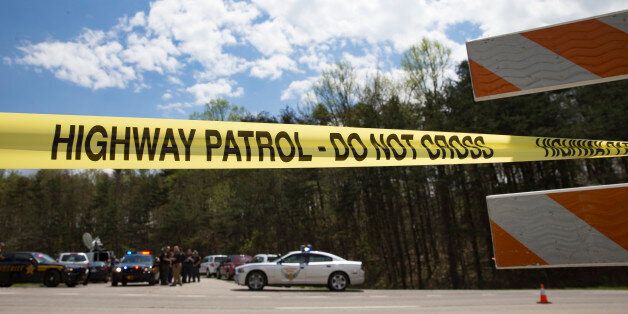 Police tape is deployed across from the Union Hill Road exit off Route 32 at a crime scene perimeter, Friday, April 22, 2016, in Pike County, Ohio. Shootings with multiple fatalities were reported along a road in rural Ohio on Friday morning, but details on the number of deaths and the whereabouts of the suspect or suspects weren't immediately clear. The attorney general's office said a dozen Bureau of Criminal Investigation agents had been called to Pike County, an economically struggling area