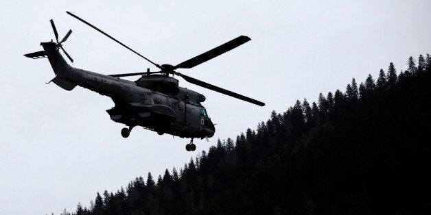 An helicopter flies over Seyne les Alpes, French Alps, Tuesday, March 24, 2015. A Germanwings passenger jet carrying at least 150 people crashed Tuesday in a snowy, remote section of the French Alps, sounding like an avalanche as it scattered pulverized debris across the mountain. (AP Photo/Laurent Cipriani)
