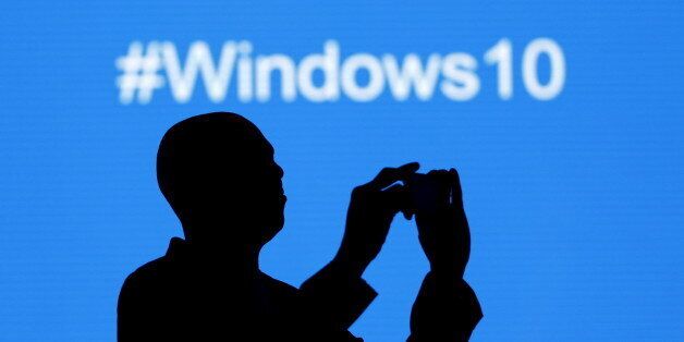 A Microsoft delegate takes a picture during the launch of the Windows 10 operating system in Kenya's capital Nairobi, July 29, 2015. Microsoft Corp's launch of its first new operating system in almost three years, designed to work across laptops, desktop and smartphones, won mostly positive reviews for its user-friendly and feature-packed interface. REUTERS/Thomas Mukoya