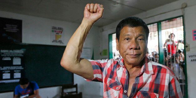 Front-running presidential candidate Mayor Rodrigo Duterte clenches his fist prior to voting in a polling precinct at Daniel R. Aguinaldo National High School at Matina district, his hometown in Davao city in southern Philippines Monday, May 9, 2016. Duterte was the last to vote among five presidential hopefuls. (AP Photo/Bullit Marquez)