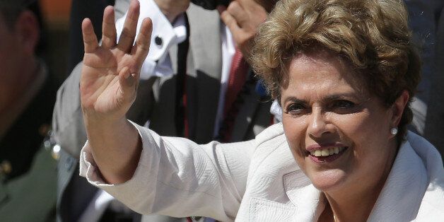 Brazilian President Dilma Rousseff greets supporters as she leaves Planalto president palace in Brasilia, Brazil, Thursday, May 12, 2016.  Hours after the Senate voted to suspend her, Rousseff blasted the impeachment process against her as