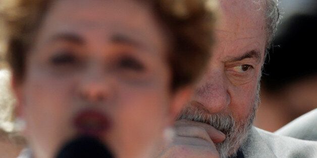 Brazil's former President Luiz Inacio Lula da Silva (R) listens as suspended President Dilma Rousseff addresses supporters, after the Brazilian Senate voted to impeach her for breaking budget laws, at Planalto Palace in Brasilia, Brazil, May 12, 2016.   REUTERS/Ueslei Marcelino        TPX IMAGES OF THE DAY
