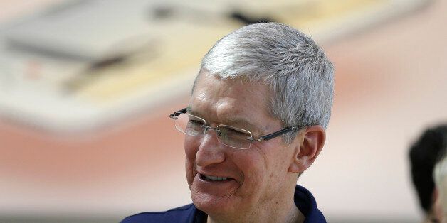 Apple CEO Tim Cook visits with customers at the Apple Store Thursday, March 31, 2016, in Palo Alto, Calif. The new Apple iPhone SE and 9.7 inch iPad Pro were available for sale on Thursday. (AP Photo/Eric Risberg)