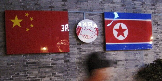 Flags of China and North Korea are seen outside the closed Ryugyong Korean Restaurant in Ningbo, Zhejiang province, China, April 12, 2016. REUTERS/Joseph Campbell