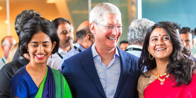 In this Handout photograph provided by Apple Media office, Apple chief Tim Cook talks with Indian colleagues during the inauguration of the Apple's Map development office in Hyderabad, India, Thursday, May 19, 2016. Apple will set up an app design and development center in southern India, the company announced Wednesday, shortly after company chief Tim Cook arrived in the country on his first visit. (Noel David/Apple via AP)