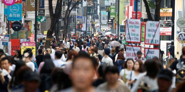 People walk in Myeongdong shopping district in Seoul, South Korea, May 31, 2016.  REUTERS/Kim Hong-Ji