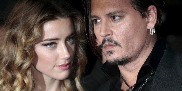 Cast member Johnny Depp and his actress wife Amber Heard arrive for the British premiere of the film