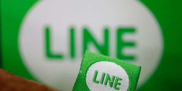 The logo of free messaging app Line is pictured on a smartphone and the company's stuffed toy in this photo illustration taken in Tokyo September 23, 2014. Naver Corp held off on an IPO for its Line Corp unit on the belief that the messaging app operator can command a better valuation by further building its revenue and profit, Naver's chief financial officer told Reuters on Tuesday. South Korea-based Naver said on Monday that it does not plan an initial public offering for Line this year, dashi