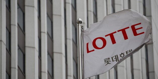 A flag bearing the logo of Lotte Hotel flutters at a Lotte Hotel in Seoul, South Korea, March 25, 2016. Riding a Seoul stocks revival, some of South Korea's biggest family firms, including Lotte, are set to clean house this year with multi-billion dollar initial public offerings that will fire the country to a record year for new listings. REUTERS/Kim Hong-Ji