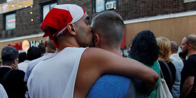 A couple embraces during a vigil for the Orlando massacre victims in the Queens borough of New York, U.S., June 12, 2016.  REUTERS/Shannon Stapleton