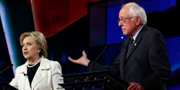 Democratic U.S. presidential candidate Hillary Clinton (L) speaks as rival candidate Senator Bernie Sanders gestures during a Democratic debate hosted by CNN and New York One at the Brooklyn Navy Yard in New York April 14, 2016. REUTERS/Lucas Jackson