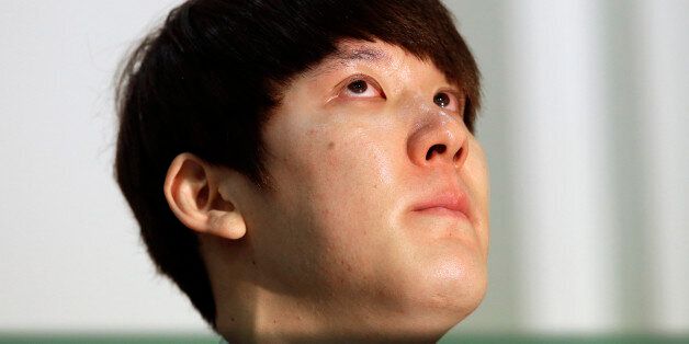 In this Friday, March 27, 2015, file photo, Former Olympic swimming champion Park Tae-hwan of South Korea holds back tears during a news conference in Seoul, South Korea. Former Olympic swimming champion Park Tae-hwan of South Korea offered a public apology Friday, four days after receiving an 18-month ban for failing a doping test. (AP Photo/Lee Jin-man)