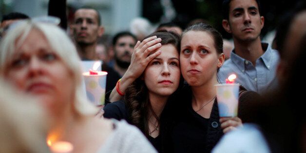 Kassandra Shore, 25, (L) and Candice Darden, 29, hold candles at a vigil in memory of victims one day after a mass shooting at the Pulse gay nightclub in Orlando, in Los Angeles, California, U.S. June 13, 2016. REUTERS/Lucy Nicholson