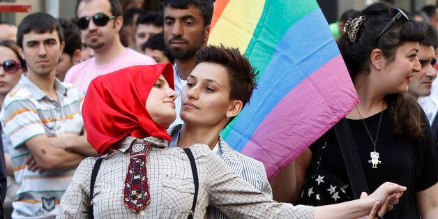 Participants dance during a gay pride parade in central Istanbul June 26, 2011. REUTERS/Murad Sezer (TURKEY - Tags: SOCIETY)