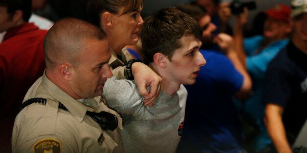 FILE - In this June 18, 2016, file photo, police remove protestor Michael Steven Sandford as Republican presidential candidate Donald Trump speaks at the Treasure Island hotel and casino in Las Vegas. Sandford, a British man accused of trying to take a police officer's gun and kill Donald Trump during a weekend rally in Las Vegas, will not be released on bail. Federal Magistrate Judge George Foley said at a hearing Monday that Sandford was a potential danger to the community and a flight risk. (