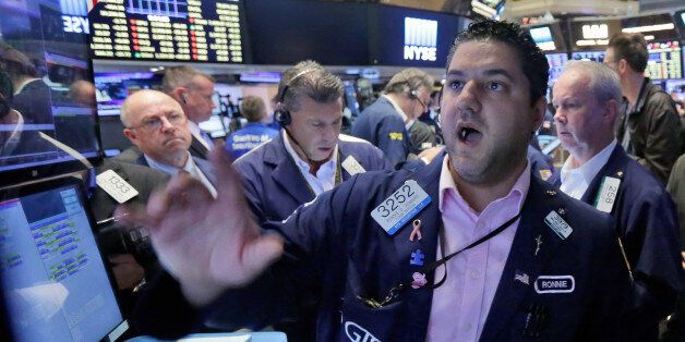 Specialist Ronnie Howard, foreground, works with traders at his post on the floor of the New York Stock Exchange, Friday, June 24, 2016. U.S. stocks are plunging in early trading after Britons voted to leave the European Union. (AP Photo/Richard Drew)