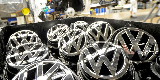 Emblems of VW Golf VII car are pictured in a production line at the plant of German carmaker Volkswagen in Wolfsburg, February 25, 2013. REUTERS/Fabian Bimmer/File Photo