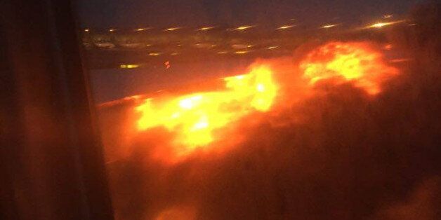 This image provided by Lee Bee Yee shows an engine on fire on a Singapore Airlines flight on Monday, June 27, 2016. A Singapore Airlines statement said the Boeing 777-300ER was on its way to Milan when it turned back