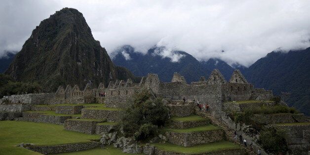 Visitors walk at the Inca citadel of Machu Picchu in Cusco, Peru, August 12, 2015. Machu Picchu, a UNESCO World Heritage Site, is Peru's top tourist attraction, with the government limiting tourists to 2,500 per day due to safety reasons and concerns over the preservation of the ruins. The Machu Picchu and Huayna Picchu mountains will be undergoing maintenance works, therefore suspending visitors from the areas, in the month of April 2016, according to Archaeological Park director Fernando Astet