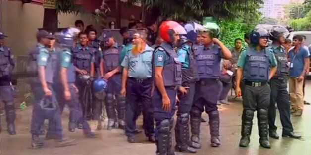 Police gather after gunmen attacked the Holey Artisan restaurant and took hostages early on Saturday, in Dhaka, Bangladesh in this still frame taken from live video July 2, 2016. REUTERS/REUTERS TV