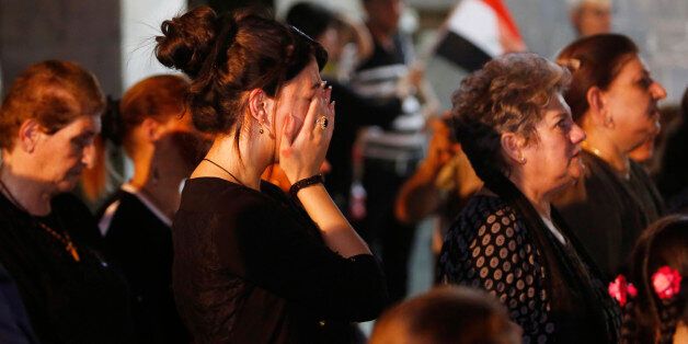 Iraqi Christians react during a mass for the victims of Sunday's truck bomb attack in Karada neighborhood in Baghdad, at St. Trazia Church in Basra, 340 miles (550 kilometers) southeast of Baghdad, Iraq, Wednesday, July 6, 2016. (AP Photo/Nabil al-Jurani)