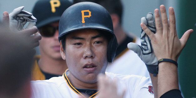 Aug 22, 2015; Pittsburgh, PA, USA; Pittsburgh Pirates shortstop Jung Ho Kang (27) is greeted in the dugout after hitting his second solo home run of the game against the San Francisco Giants during the seventh inning at PNC Park. The Pirates won 3-2. Mandatory Credit: Charles LeClaire-USA TODAY Sports