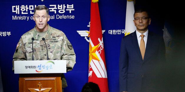 Lt. Gen. Thomas Vandal, the commander of U.S. Forces Korea's Eighth Army, center, speaks to the media about deploying the Terminal High-Altitude Area Defense, or THAAD as South Korean Defense Ministry's deputy minister for policy Yoo Jeh-seung, right, listens during a media briefing at the Defense Ministry in Seoul, South Korea, Friday, July 8, 2016. (AP Photo/Lee Jin-man)