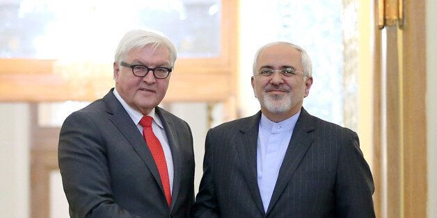Iranian Foreign Minister Mohammad Javad Zarif, right, and his German counterpart Frank-Walter Steinmeier shake hands as they pose for photos at the end of their press conference in Tehran, Iran, Tuesday, Feb. 2, 2016. (AP Photo/Ebrahim Noroozi)