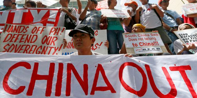 Protesters display their message during a rally outside of the Chinese Consulate hours before the Hague-based UN international arbitration tribunal is to announce its ruling on South China Sea Tuesday, July 12, 2016, in Makati city east of Manila, Philippines. The protesters are urging China to respect the Philippines' rights over its exclusive economic zone and extended continental shelf as mandated by the UN Convention of the Law of the Sea or UNCLOS. (AP Photo/Bullit Marquez)