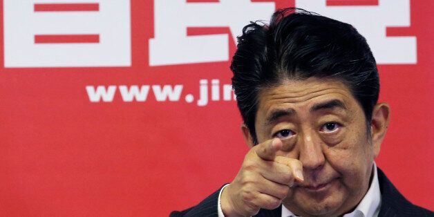 Japanese Prime Minister and leader of the ruling Liberal Democratic Party, Shinzo Abe, points a reporter for questions during a press conference in Tokyo, Monday, July 11, 2016. A resounding election victory for Abeâs ruling bloc has opened the door a crack for his long-cherished ambition to revise the constitution for the first time since it was enacted in 1947 - a behind-the-scenes agenda that could over time change Japanâs future. (AP Photo/Koji Sasahara)