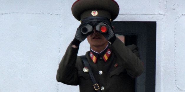 A North Korean soldier looks through binoculars on the Yalu River in Sinuiju, opposite the Chinese border city of Dandong, May 1, 2016. Picture taken from China's side of the Yalu. REUTERS/Jacky Chen