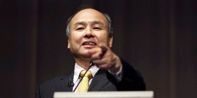 FILE - In this Nov. 4, 2014 file photo, SoftBank founder and Chief Executive Officer Masayoshi Son speaks during a news conference in Tokyo. Japanese Internet company SoftBank Group Corp., which is struggling to turn around Sprint in the U.S., is reporting a 27 percent drop in profit for the fiscal year ended March 31, compared to the previous year. (AP Photo/Eugene Hoshiko, File)