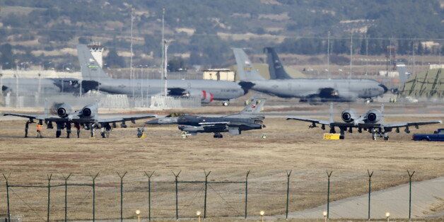 A Turkish Air Force F-16 fighter jet ( C foreground) is seen between U.S. Air Force A-10 Thunderbolt II fighter jets at Incirlik airbase in the southern city of Adana, Turkey, December 11, 2015. REUTERS/Umit Bektas