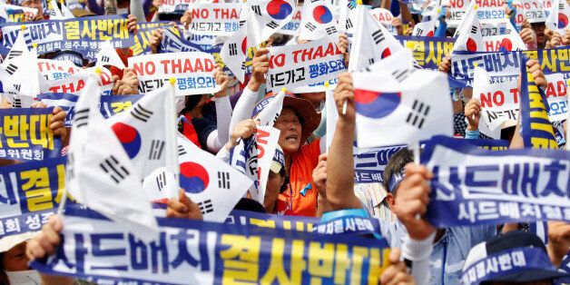 Seoungju residents chant slogans during a protest against the government's decision on deploying a U.S. THAAD anti-missile defense unit in Seongju, in Seoul, South Korea, July 21, 2016. The banner reads