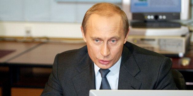 Russian President Vladimir Putin sits at a desktop computer in Moscow's Kremlin, January 19, 2004. Putin on Monday attended the presentation of the presidential web-site called