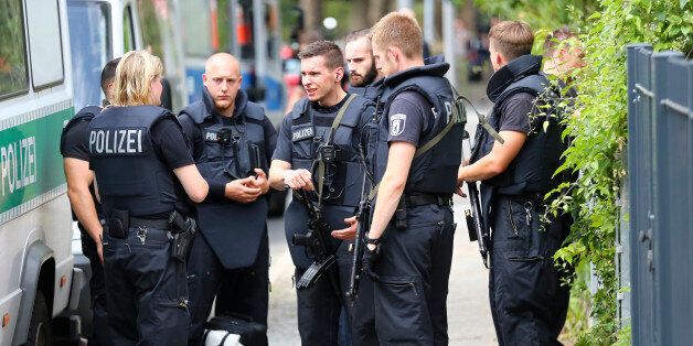 Special police stand outside the university clinic in Steglitz, a southwestern district of Berlin, July 26, 2016 after a doctor had been shot at and the gunman had killed himself.    REUTERS/Hannibal Hanschke