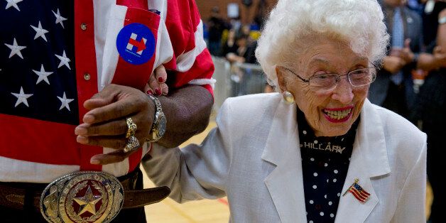 John Goodie escorts 101-year-old Jerry Emmett, of Prescott, Ariz., a supporter of Democratic presidential candidate Hillary Clinton, to her seat before Clinton arrives to speak at a campaign event at Carl Hayden Community High School in Phoenix on Monday, March 21, 2016. (AP Photo/Carolyn Kaster)