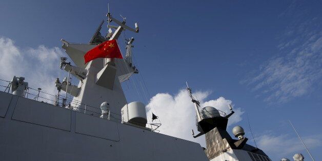 A Chinese People's Liberation Army (PLA) navy personnel looks out of their Jiangkai II class vessel, CNS Yulin,  during a display of warships ahead of the IMDEX Asia maritime defence exhibition at Changi Naval Base in Singapore May 18, 2015. The 10th international maritime defence show which sees participation from 180 exhibitors and delegations from over 40 countries takes place from May 19 to 21. REUTERS/Edgar Su