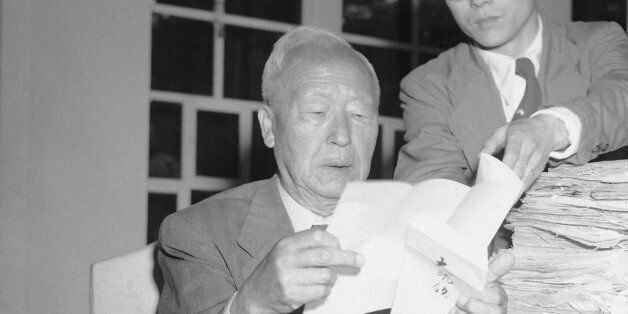 Syngman Rhee (seated), President of Republic of Korea who is reported to have received a letter on current political crisis in his land from  President Harrt Truman  goes over petitions from South Koreans on the issue of electing a President by popular vote rather than by the National Assembly. He is shown with aide in his office in Pusan on May 29, 1953. Truman wrote that he was âshockedâ by the crisis in which Rheeâs police had arrested 12 members of the strongly anti-Rhee Assem