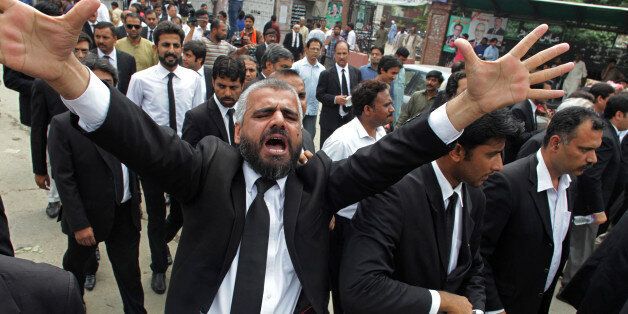 A Pakistan lawyer shouts slogans during a demonstration to condemn a suiciding bombing in Quetta that killed dozens of people and wounded many more, in Lahore, Pakistan, Monday, Aug. 8, 2016. Senior police official Zahoor Ahmed Afridi says the blast took place shortly after the body of a prominent lawyer, killed in a shooting attack earlier in the day, was brought to the hospital. It's unclear if the two events are in any way connected. (AP Photo/K.Chaudary)
