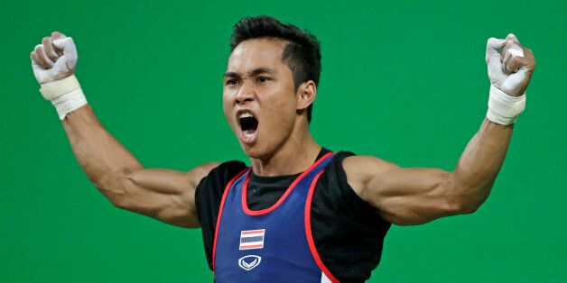 Sinphet Kruaithong, of Thailand, celebrates a successful lift in the men's 56kg weightlifting competition at the 2016 Summer Olympics in Rio de Janeiro, Brazil, Sunday, Aug. 7, 2016. Kruaithong won the bronze medal. (AP Photo/Mike Groll)