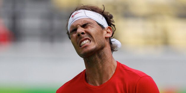Spain's Rafael Nadal grimaces after losing a point to France's Gilles Simon during the men's tennis competition at the 2016 Summer Olympics in Rio de Janeiro, Brazil, Thursday, Aug. 11, 2016. (AP Photo/Vadim Ghirda)