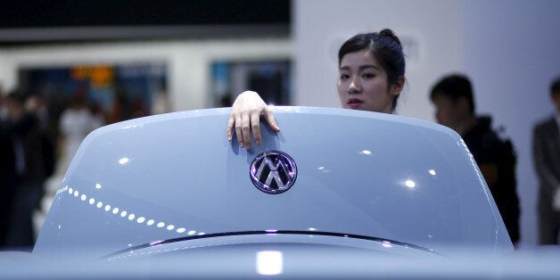 A woman looks a Volkswagen car during a presentation at the 16th Shanghai International Automobile Industry Exhibition in Shanghai, April 21, 2015. REUTERS/Aly Song/File Photo