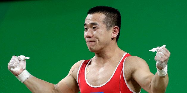 Om Yun Chol, of North Korea, celebrates a successful lift in the men's 56kg weightlifting competition at the 2016 Summer Olympics in Rio de Janeiro, Brazil, Sunday, Aug. 7, 2016. (AP Photo/Mike Groll)