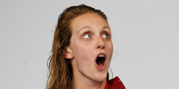 England's Francesca Halsall sings her national anthem after winning the gold medal in the women's 50m Freestyle final at the Commonwealth Games in Glasgow, Scotland, July 26, 2014. REUTERS/Jim Young (BRITAIN - Tags: SPORT SWIMMING)