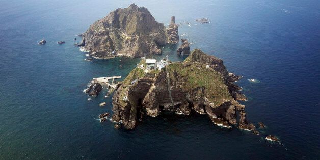 A set of remote islands called Dokdo in Korean and Takeshima in Japanese is seen in this picture taken from a helicopter carrying South Korean President Lee Myung-bak (not pictured), east of Seoul August 10, 2012. Lee visited the islands on Friday, angering neighbour Japan which also lays claims to territory. South Korea controls the islands with a coast guard presence and plans to beef up maritime research.   REUTERS/The Blue House/Handout   (POLITICS)   FOR EDITORIAL USE ONLY. NOT FOR SALE FOR MARKETING OR ADVERTISING CAMPAIGNS. THIS IMAGE HAS BEEN SUPPLIED BY A THIRD PARTY. IT IS DISTRIBUTED, EXACTLY AS RECEIVED BY REUTERS, AS A SERVICE TO CLIENTS
