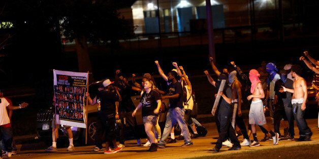 Protestors march toward police lines during disturbances following the police shooting of a man in Milwaukee, Wisconsin, U.S. August 14, 2016. REUTERS/Aaron P. Bernstein