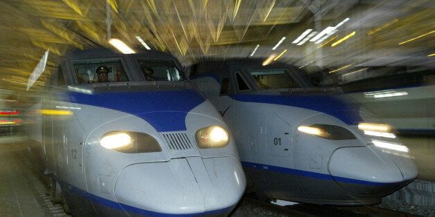 A South Korean KTX train (L) prepares to depart for Pusan city at the Seoul railway station April 1, 2004. South Korea's first high-speed railway service began before dawn on Thursday when a sleek, French-designed bullet train slipped out of Seoul bound for the southern port city of Pusan, now less than three hours away. REUTERS/Kim Kyung-Hoon  KKH/GB